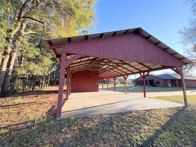 view of community featuring a lawn and a detached carport