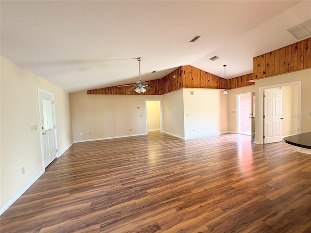 spare room featuring lofted ceiling, ceiling fan, visible vents, and dark wood finished floors