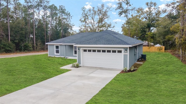 ranch-style house featuring driveway, a garage, a shingled roof, central AC, and a front yard