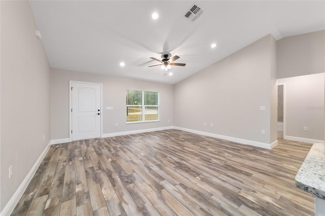 empty room featuring light wood-style floors, visible vents, baseboards, and a ceiling fan