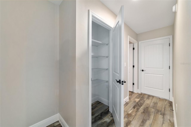 interior space with wood finished floors and baseboards