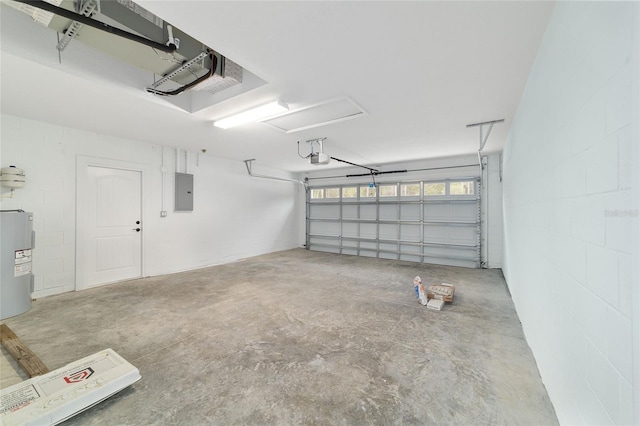 garage featuring a garage door opener, concrete block wall, electric water heater, and electric panel