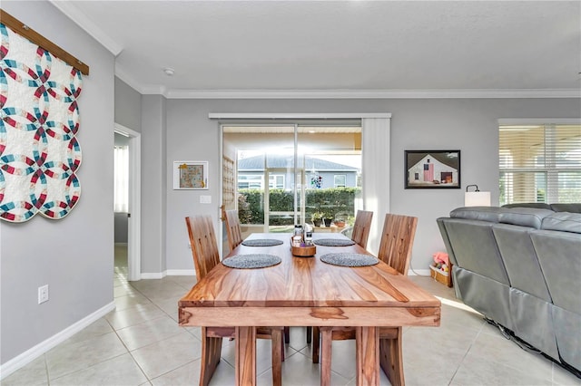 dining space featuring light tile patterned floors, plenty of natural light, and ornamental molding