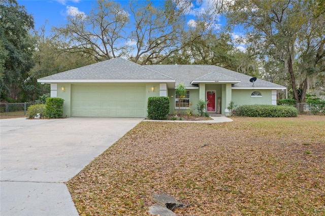 ranch-style house featuring a garage, concrete driveway, fence, and stucco siding