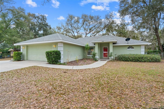 ranch-style home with a garage, a front yard, driveway, and stucco siding