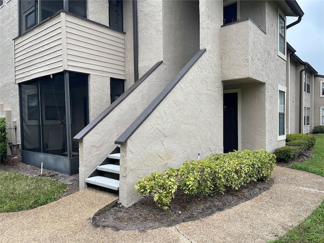 property entrance with stucco siding