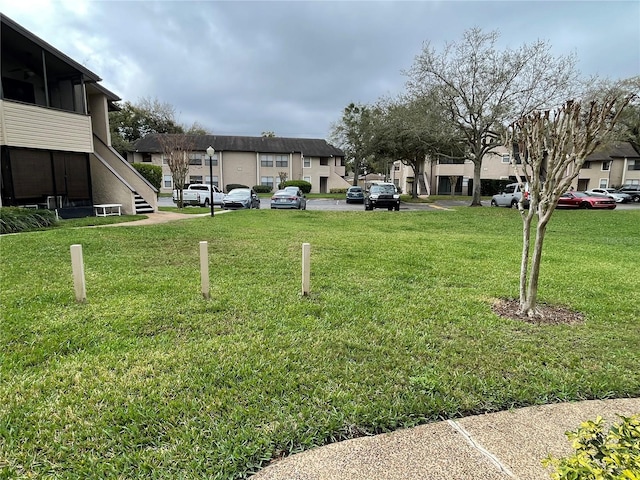 view of yard featuring a residential view and stairway