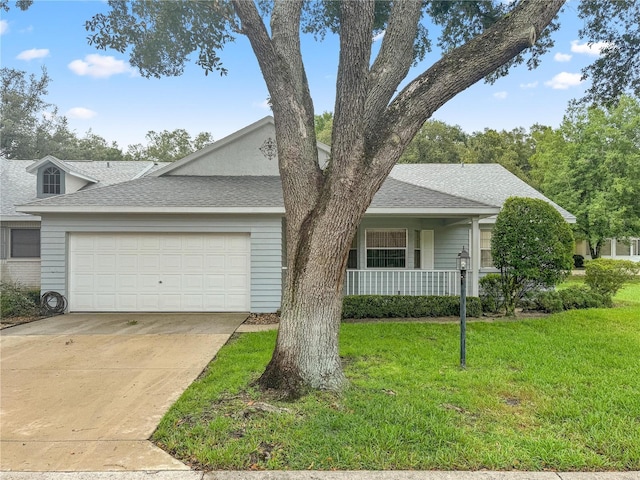 view of front facade featuring a front yard, roof with shingles, driveway, and an attached garage