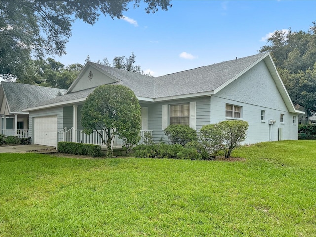 ranch-style house featuring an attached garage, roof with shingles, a porch, and a front yard