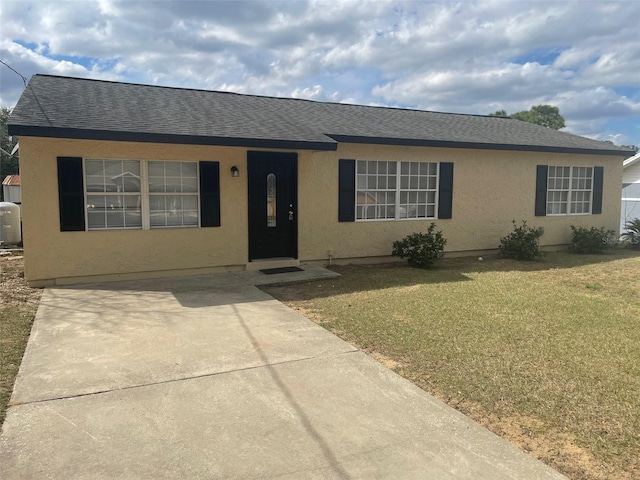 single story home featuring stucco siding, roof with shingles, and a front yard