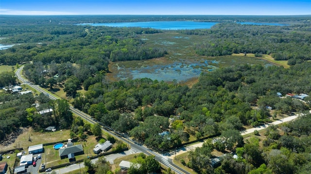 aerial view featuring a forest view and a water view