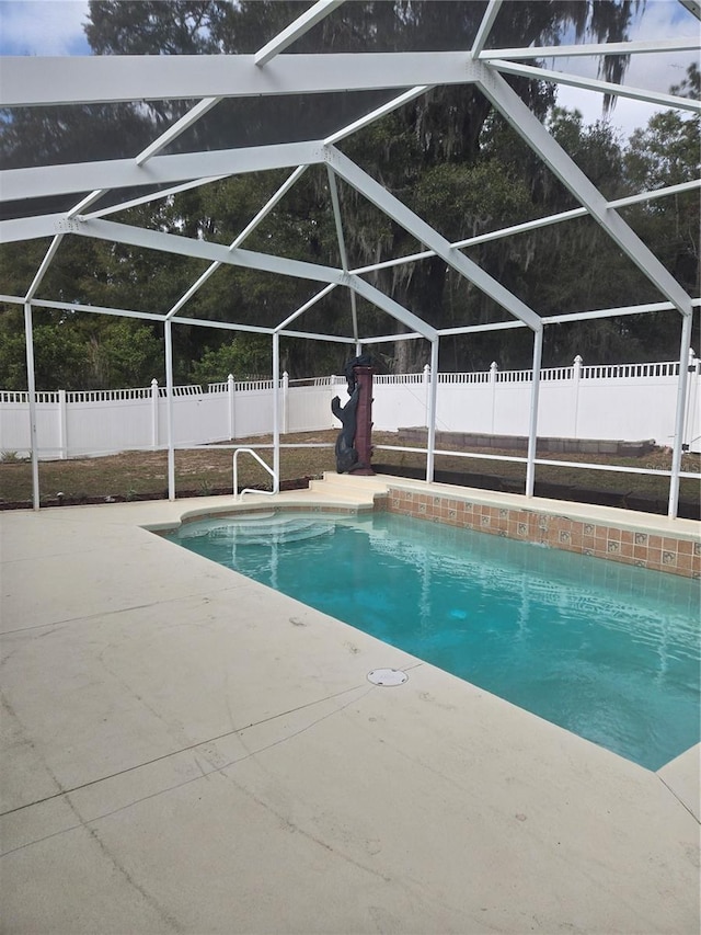 view of pool with a fenced in pool, a lanai, a patio area, and a fenced backyard