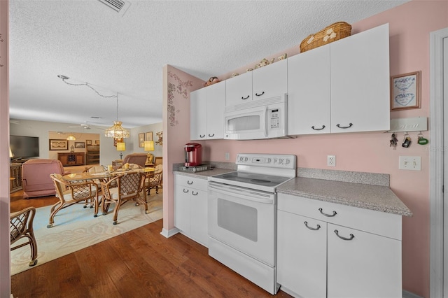 kitchen with white appliances, dark wood finished floors, open floor plan, light countertops, and white cabinetry