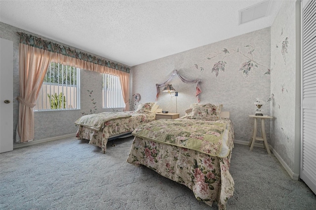 carpeted bedroom featuring wallpapered walls, baseboards, visible vents, and a textured ceiling
