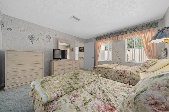 bedroom with visible vents and a textured ceiling
