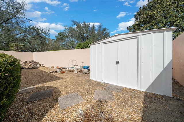 view of shed with a fenced backyard