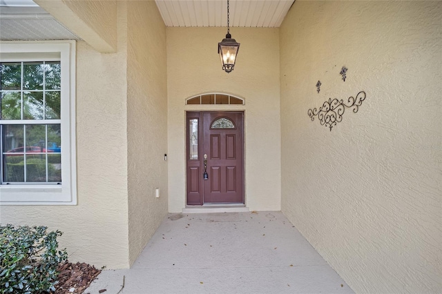 entrance to property with stucco siding