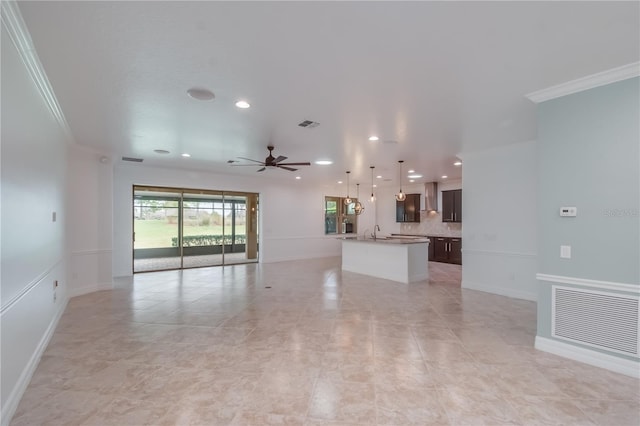 unfurnished living room featuring visible vents, ceiling fan, crown molding, a sink, and recessed lighting