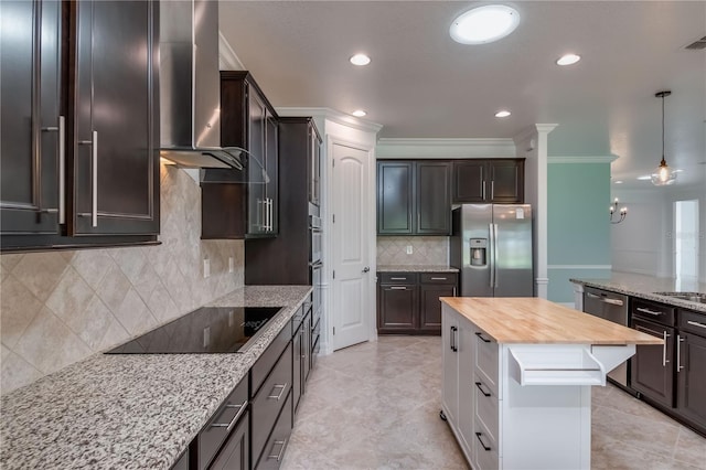 kitchen featuring crown molding, wooden counters, appliances with stainless steel finishes, a kitchen island, and wall chimney exhaust hood