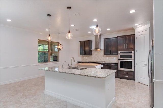 kitchen with a kitchen island with sink, black electric cooktop, stainless steel double oven, wall chimney range hood, and a sink