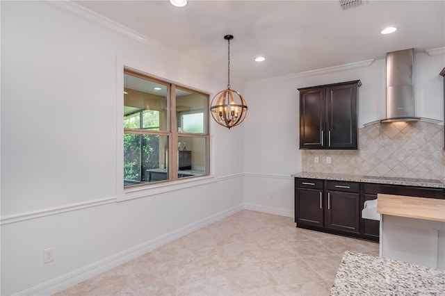 kitchen featuring wall chimney range hood, tasteful backsplash, crown molding, and dark brown cabinets