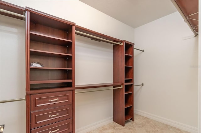 walk in closet featuring light tile patterned flooring