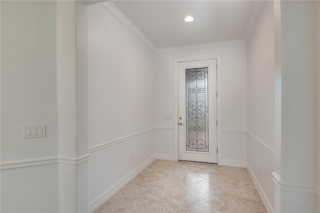 entryway featuring baseboards, ornamental molding, and light tile patterned flooring