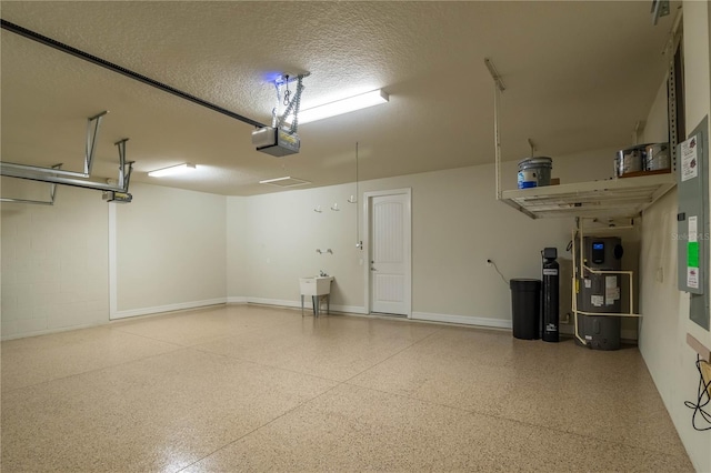 garage with baseboards, heat pump water heater, concrete block wall, and a garage door opener