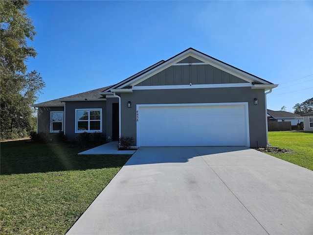 ranch-style home featuring a garage, driveway, a front lawn, and stucco siding