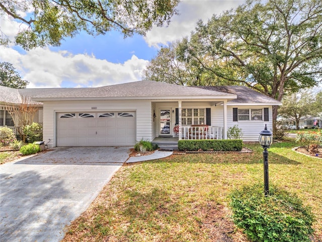 ranch-style house with covered porch, concrete driveway, an attached garage, and a front yard