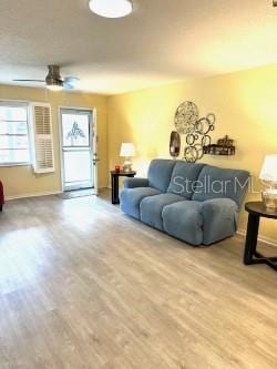 8888 SW 95th Ln Unit D, Ocala, FL 34481 - living area with wood finished floors, baseboards, and a ceiling fan