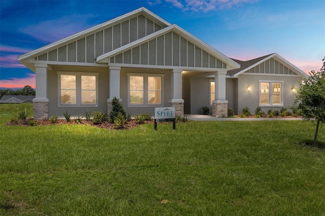 1929 NW 85th Loop, Ocala, FL 34475 - craftsman-style home with board and batten siding, a yard, and stucco siding