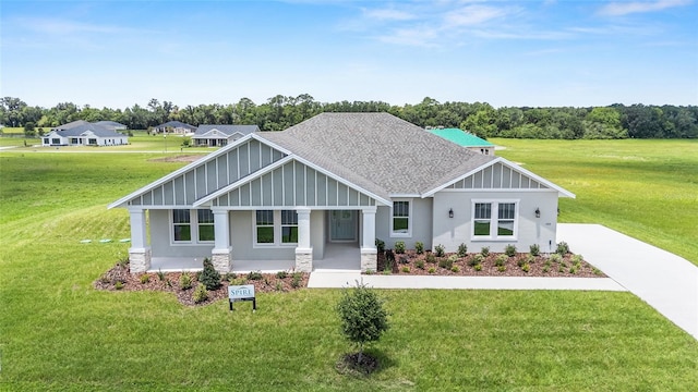 1929 NW 85th Loop, Ocala, FL 34475 - craftsman-style home featuring a front yard, roof with shingles, stone siding, and stucco siding