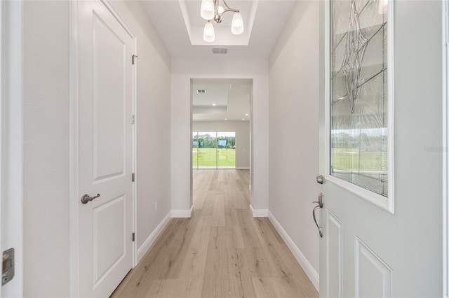 1929 NW 85th Loop, Ocala, FL 34475 - corridor with light wood-style flooring and a chandelier