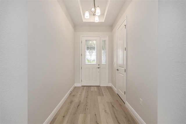 1929 NW 85th Loop, Ocala, FL 34475 - doorway with light wood-style flooring and a chandelier