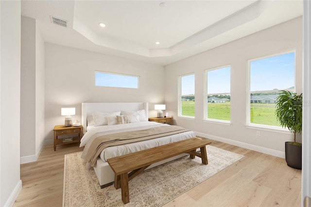1929 NW 85th Loop, Ocala, FL 34475 - bedroom with multiple windows, a raised ceiling, light wood-style flooring, and recessed lighting