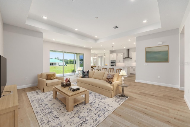 1929 NW 85th Loop, Ocala, FL 34475 - living area featuring a raised ceiling, recessed lighting, and light wood-style flooring