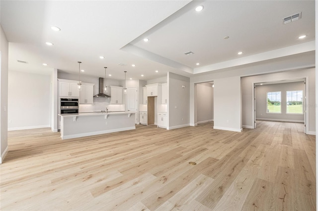 1929 NW 85th Loop, Ocala, FL 34475 - unfurnished living room with recessed lighting and light wood-style floors