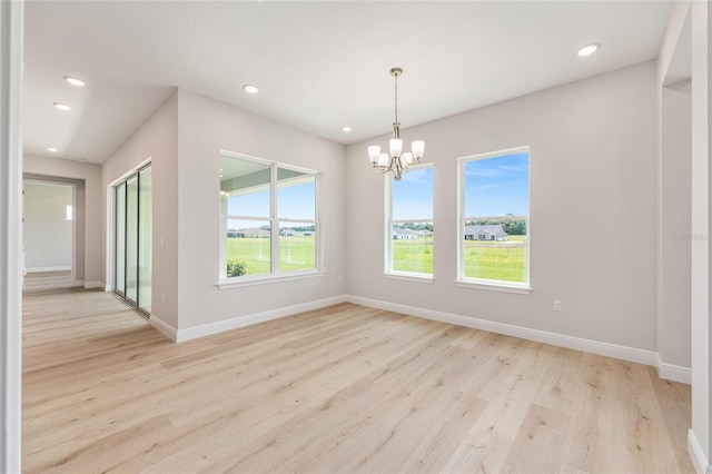 1929 NW 85th Loop, Ocala, FL 34475 - spare room featuring healthy amount of natural light, a chandelier, light wood-style flooring, and recessed lighting