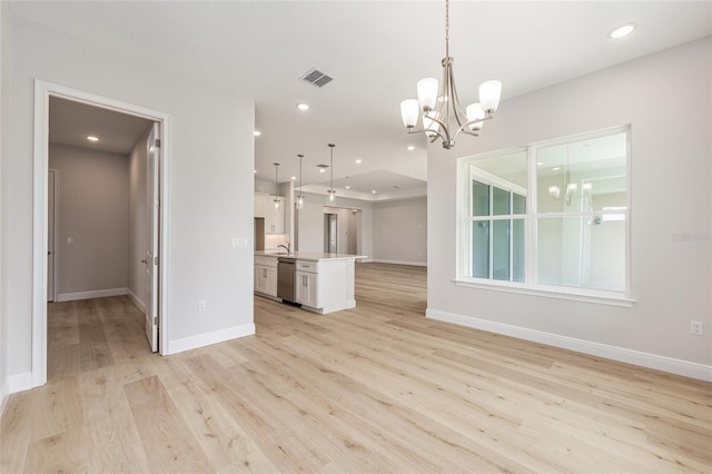 1929 NW 85th Loop, Ocala, FL 34475 - unfurnished living room featuring a chandelier, light wood finished floors, and recessed lighting