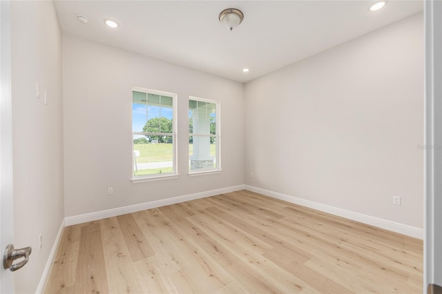 1929 NW 85th Loop, Ocala, FL 34475 - empty room with light wood finished floors, recessed lighting, and a smoke detector