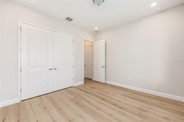 1929 NW 85th Loop, Ocala, FL 34475 - unfurnished bedroom with light wood-style flooring, a closet, and recessed lighting