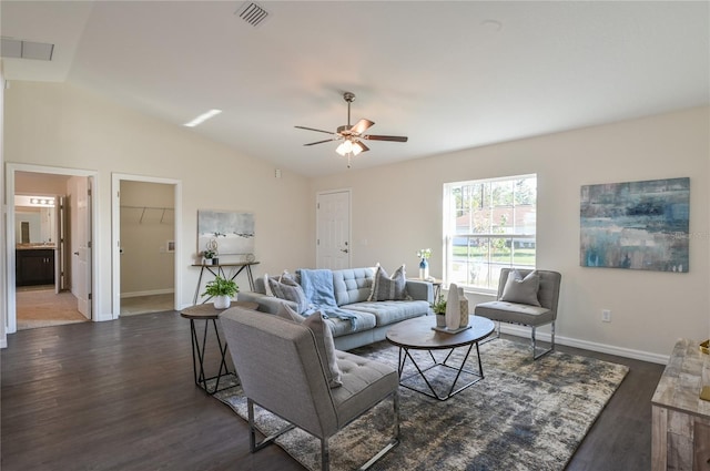 living area with dark wood-style flooring, lofted ceiling, visible vents, ceiling fan, and baseboards