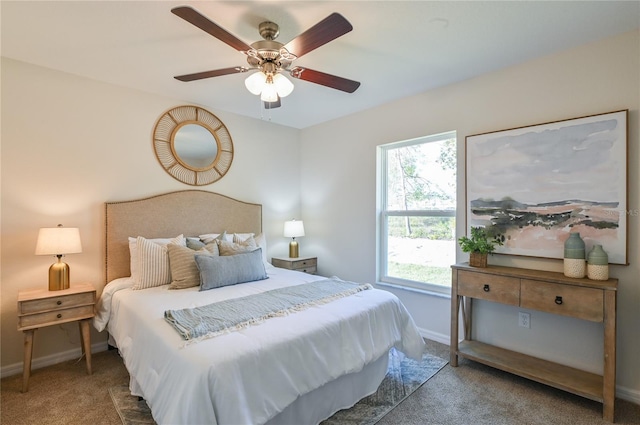 bedroom featuring ceiling fan, baseboards, and dark colored carpet