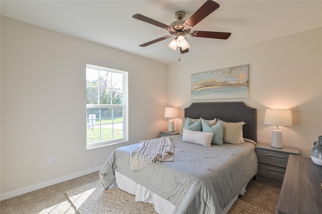 bedroom with ceiling fan, baseboards, and carpet flooring