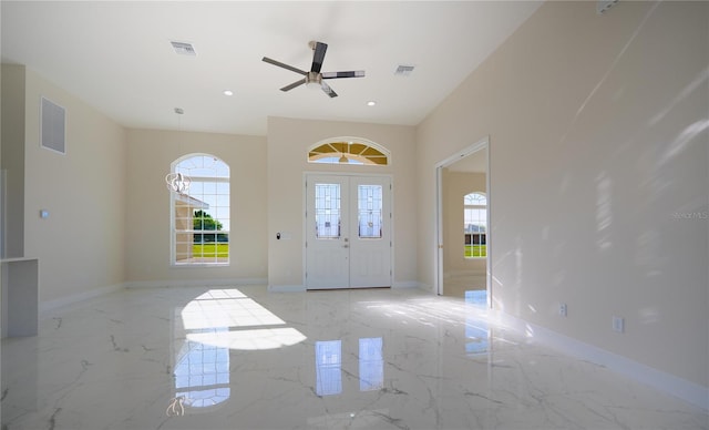 foyer entrance with visible vents, marble finish floor, and a wealth of natural light