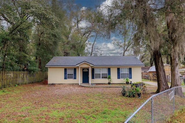 single story home with a fenced front yard