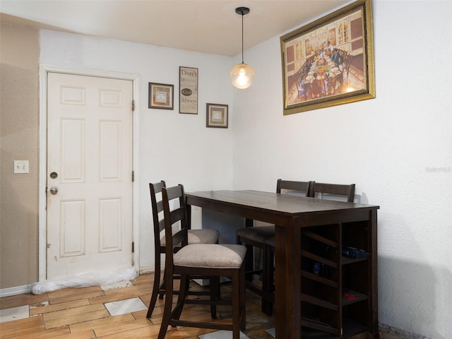 dining room with baseboards and wood finished floors