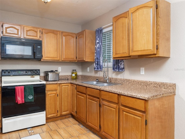 kitchen with black microwave, light countertops, range with electric cooktop, and a sink