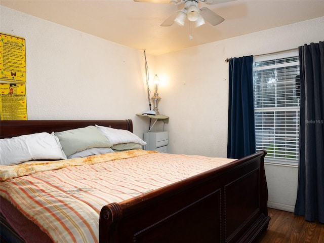 bedroom featuring a ceiling fan and dark wood finished floors